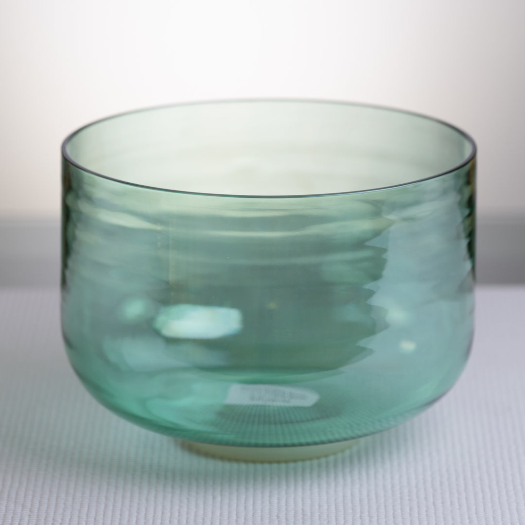 A 9.5 inch green Crystal Singing Bowl with a mallet and carrying case.