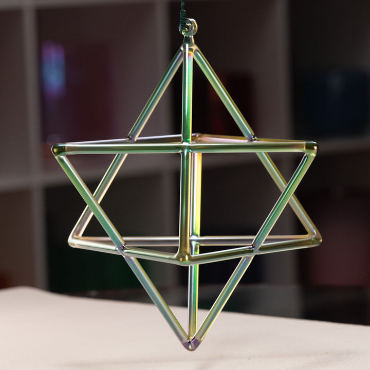 Geometric star-shaped object on a white surface with a blurred background