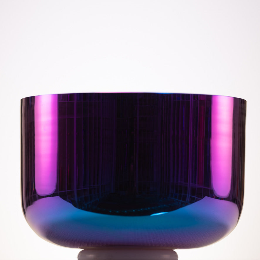Vibrant purple and blue crystal bowl on a white background