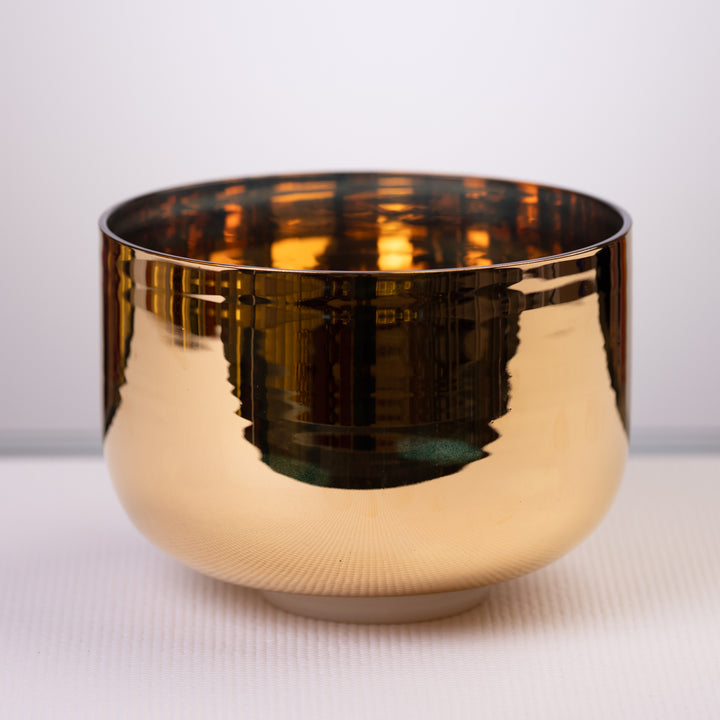 A 9.75 inch C-33 24k gold and crystal singing bowl with a reflective gold finish.