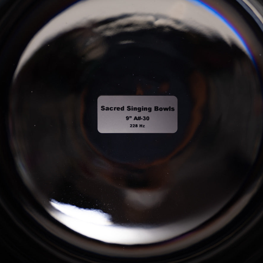 Close-up of a Sacred Singing Bowl™ with a label indicating size and frequency.