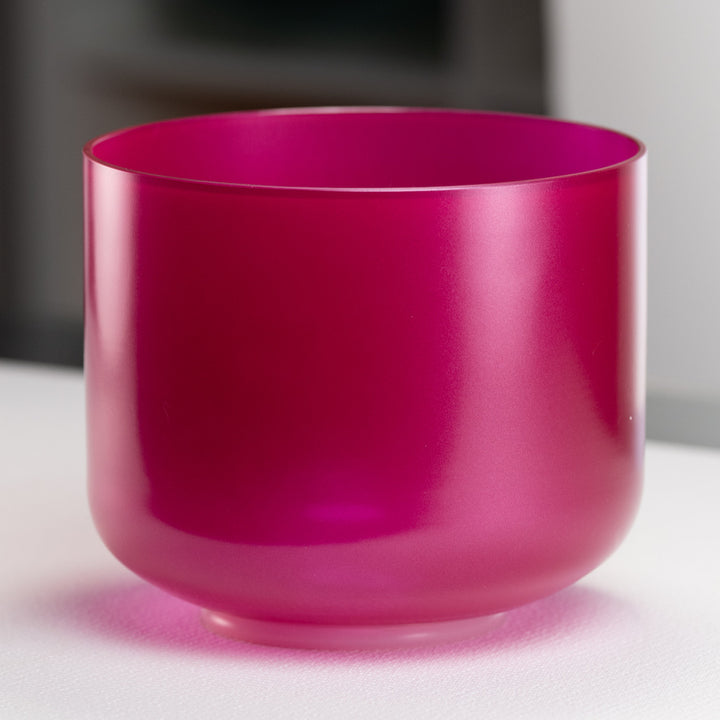 A 9-inch rose garden singing bowl in a bright pink color, with a perfect pitch of C#-3 and a resonance frequency of 276 Hz, placed on a flat surface.