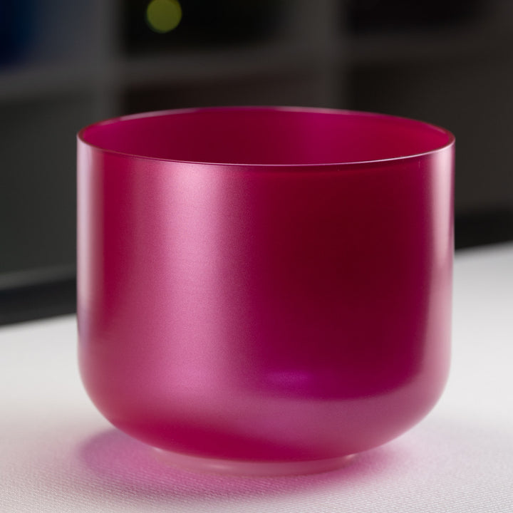 A 9-inch rose garden singing bowl with a magenta color, made from quartz crystal, displayed on a white surface.