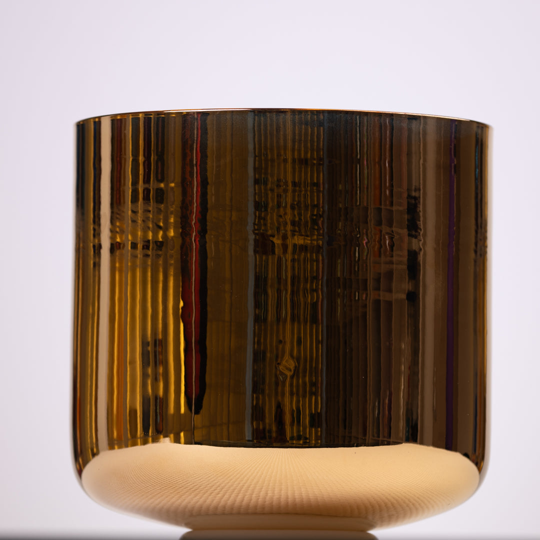 A 9 inch F#-29 24k Gold Crystal Singing Bowl with a reflective gold finish on top and a natural quartz base.