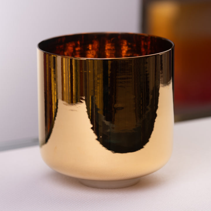 A 9 inch G-29 24k gold crystal singing bowl with a reflective gold finish, displayed on a white surface.