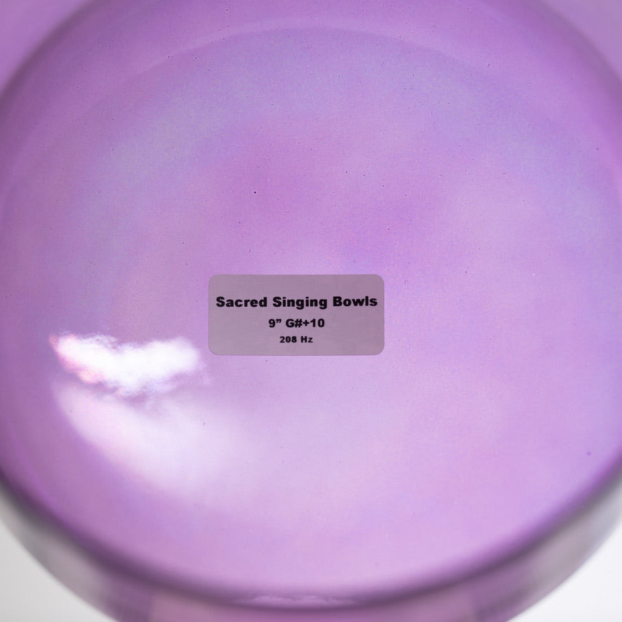 Purple singing bowl with a label indicating 'Sacred Singing Bowls' and specifications.