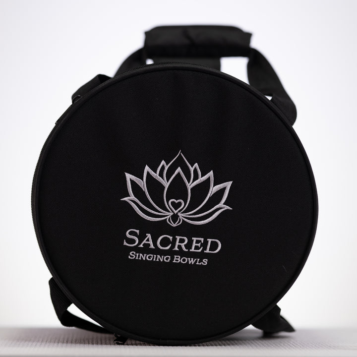 Black carrying case with 'Sacred Singing Bowls' logo on a white background