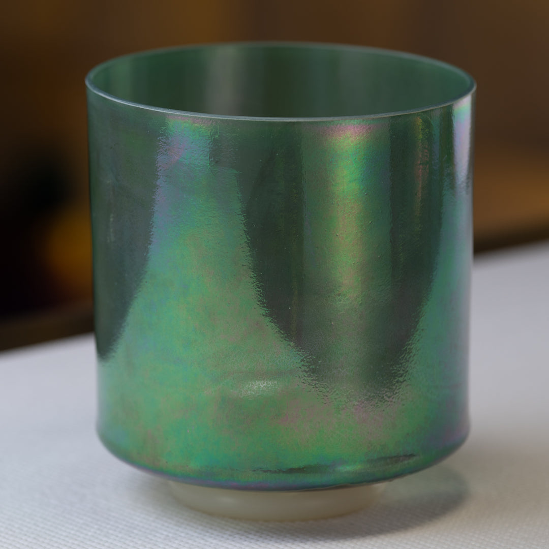 A 7-inch D-40 Malachite Platinum Crystal Singing Bowl with a green and blue iridescent surface.