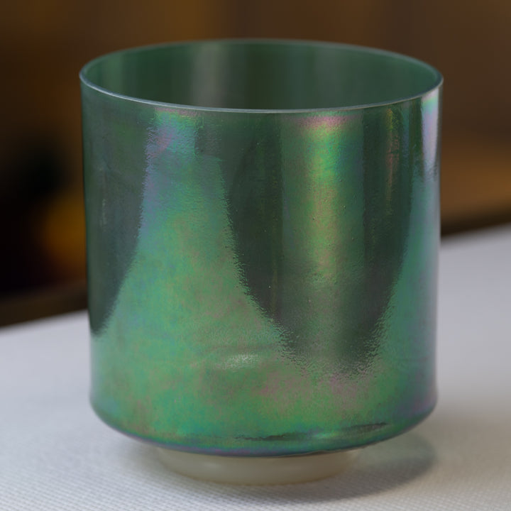A 7-inch D-40 Malachite Platinum Crystal Singing Bowl with a green and blue iridescent surface.