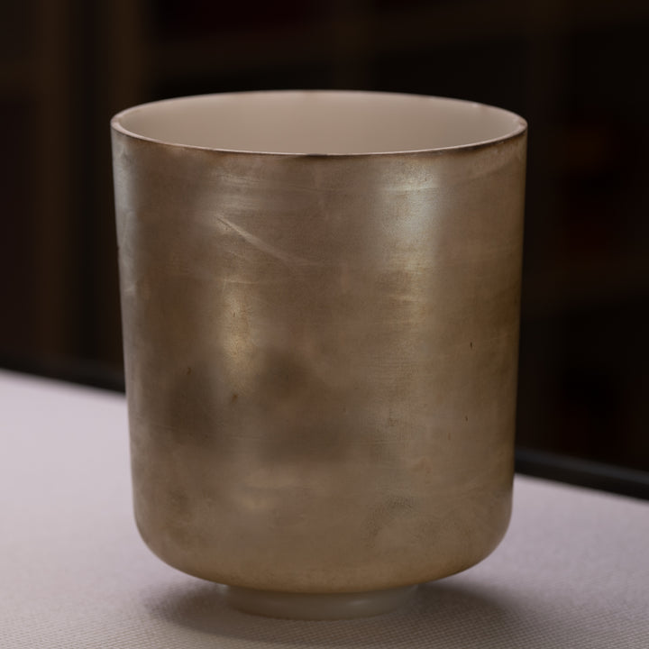 A 9 inch C#+50 Grandfather Super Tall Crystal Singing Bowl with a metallic finish.