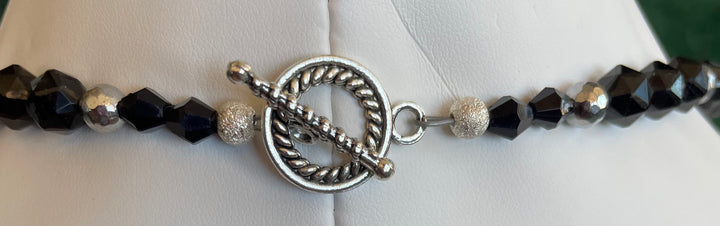 Necklace with black and silver beads on a white background