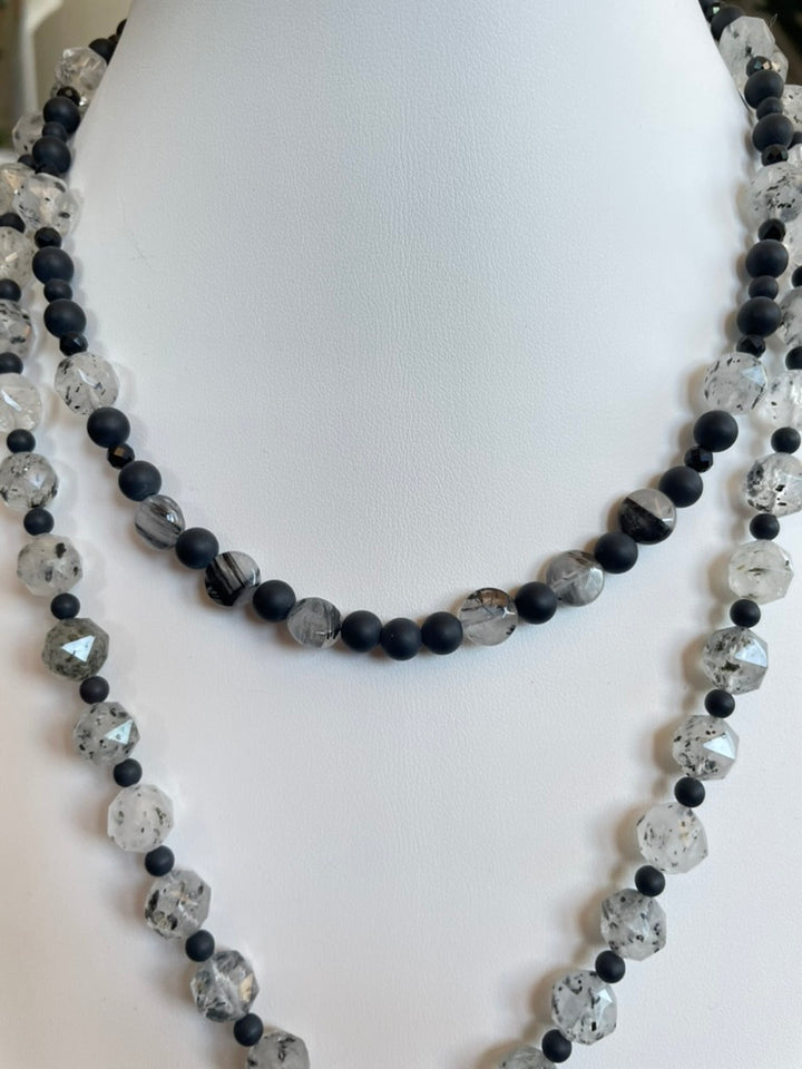 Necklace with black and gray beads on a mannequin