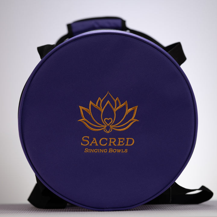 Round purple case with 'Sacred Singing Bowls' logo on a white background